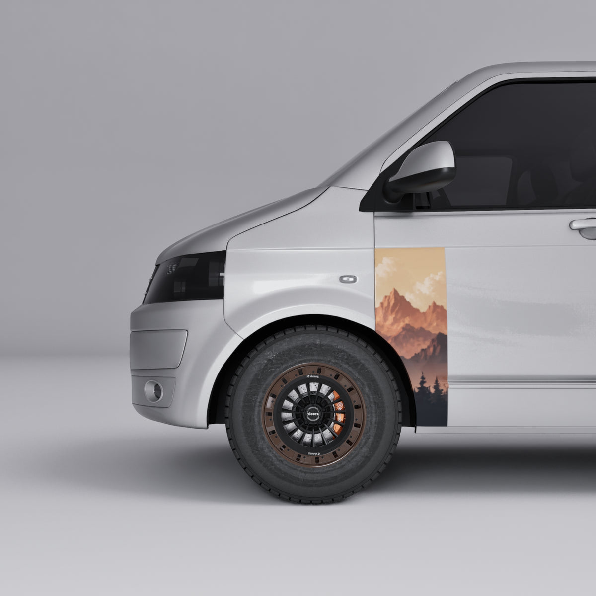 VW Transporter T5 T6 Sunset Mountain Forest Door Decal on silver van side, showcasing mountain and forest design.