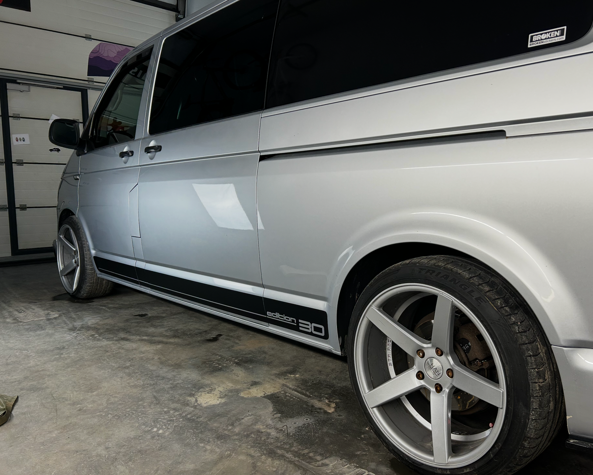 VW Transporter T6 Edition 30 Side Stripe Decal on silver van with stylish wheels in garage.