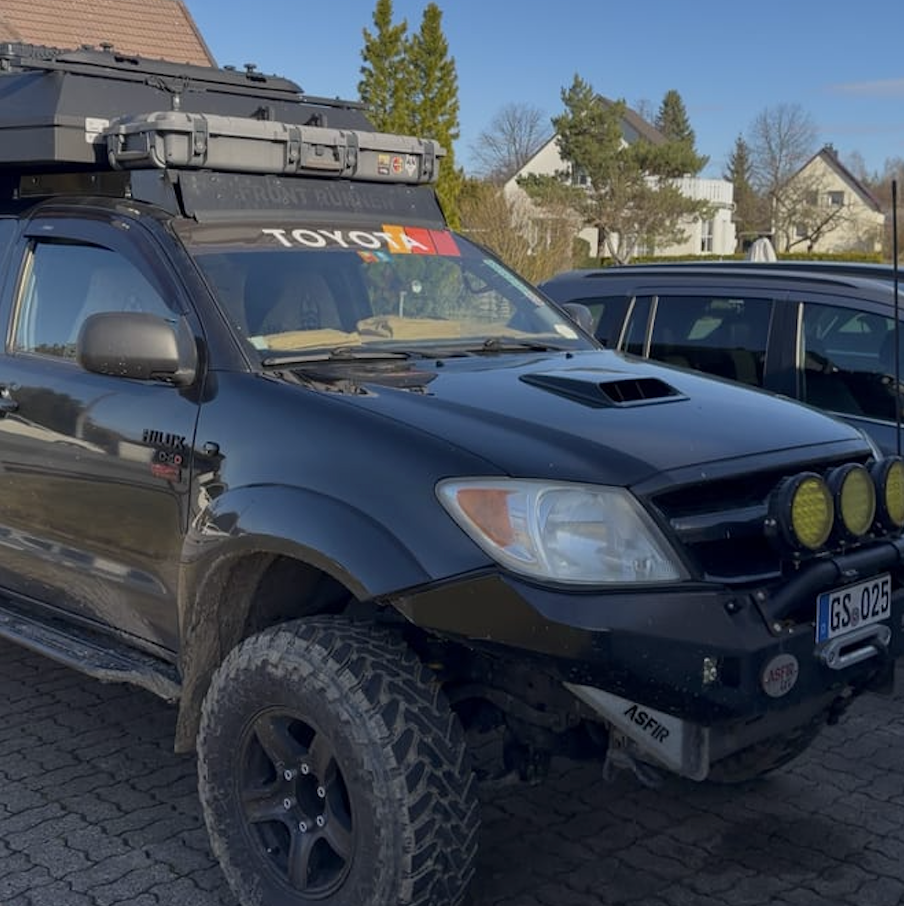Toyota Black Retro Windshield Banner Decal on black SUV with off-road features and rooftop storage.