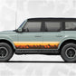 Ford Bronco Vintage Stripe Decal showcased on a classic Ford Bronco with sunset colors and mountain silhouettes.