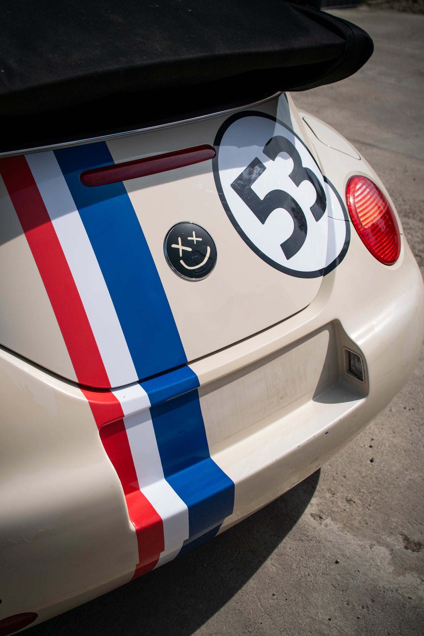 Rear view of VW Beetle with retro racing kit showing bonnet stripe and number roundel