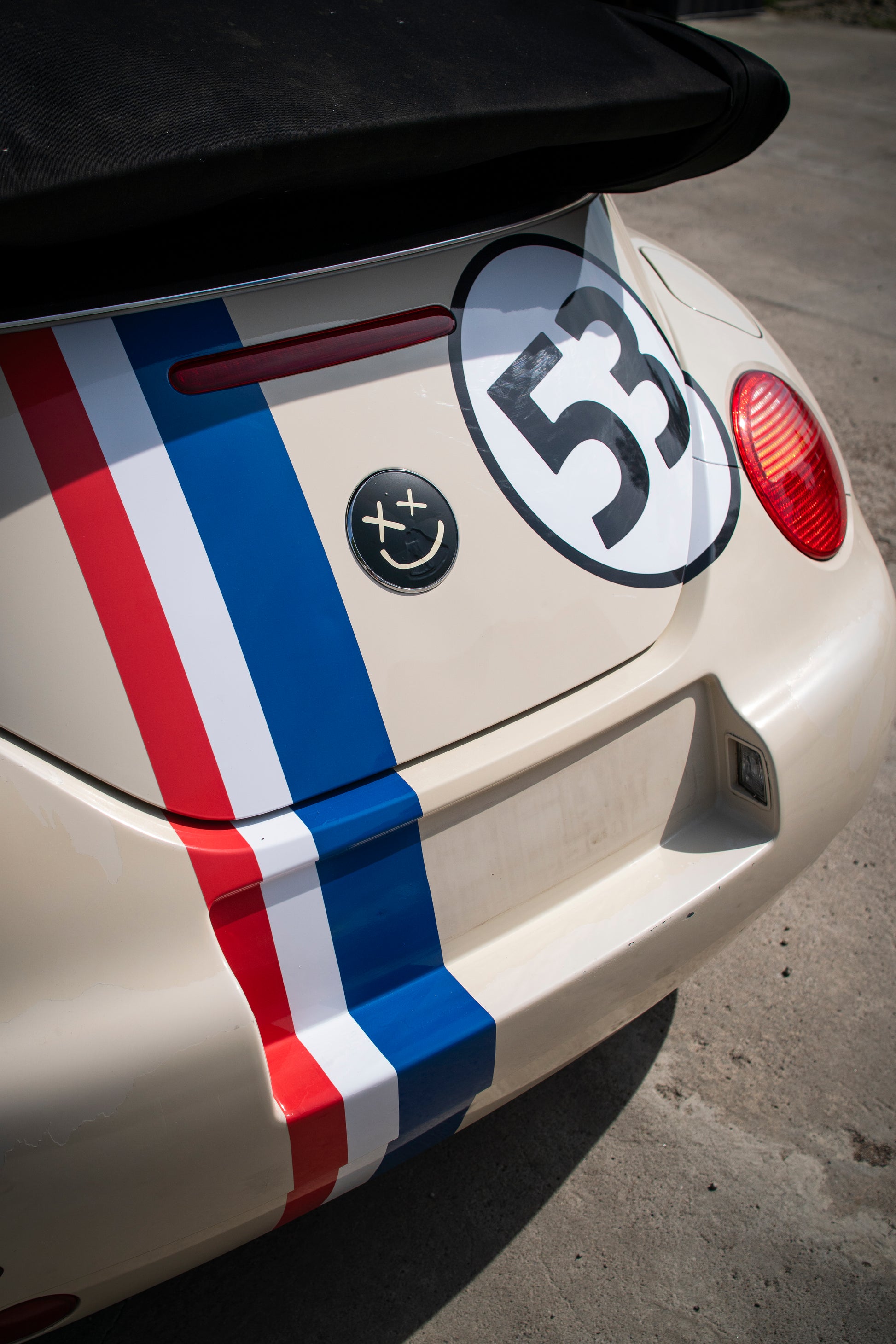 Rear view of VW Beetle with retro racing kit showing bonnet stripe and number roundel