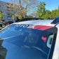 Toyota Black Retro Windshield Banner Decal on a car windshield in an outdoor setting.