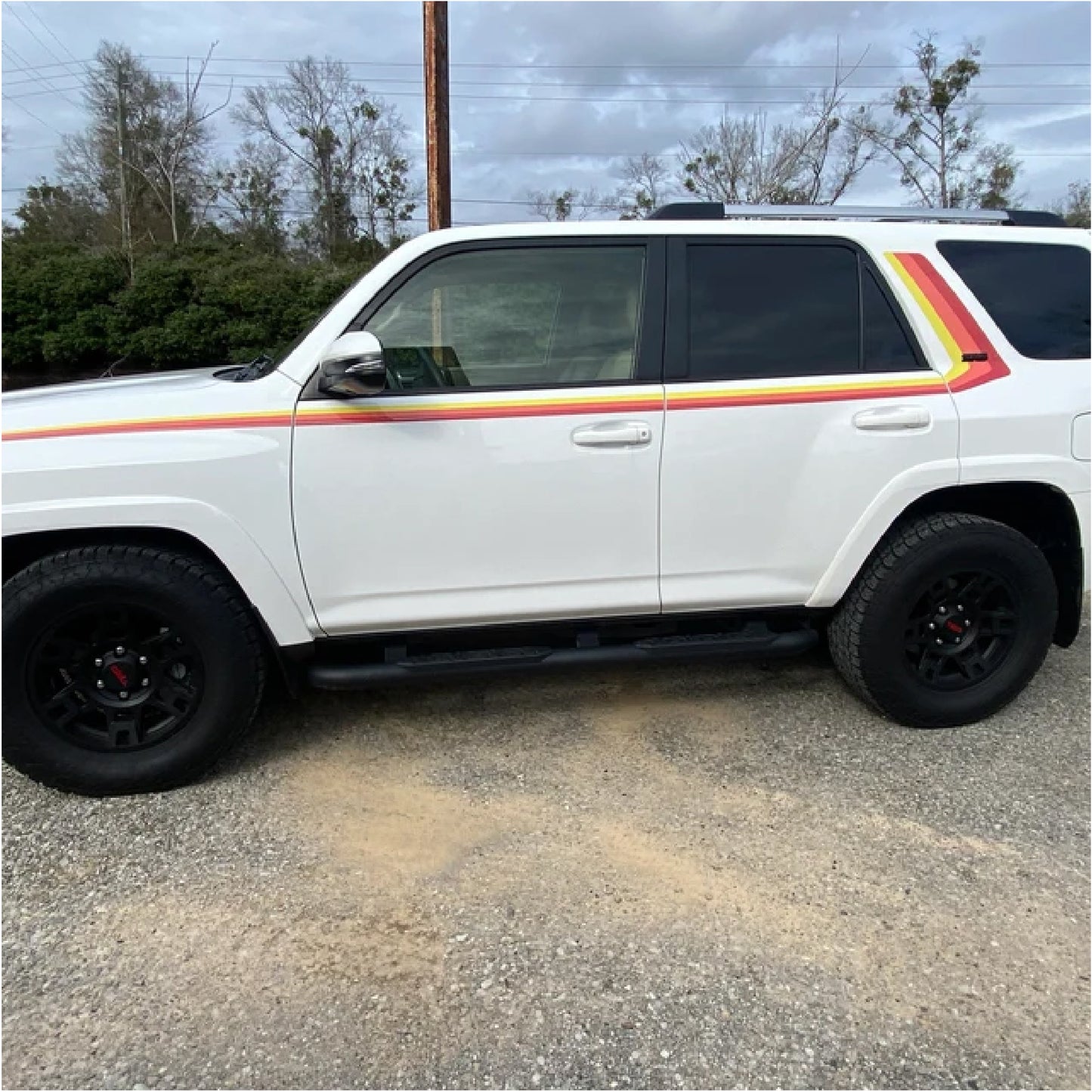 White Toyota 4runner with retro side stripe graphics