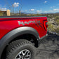 Red Ford Raptor with black matte bedside claw decals