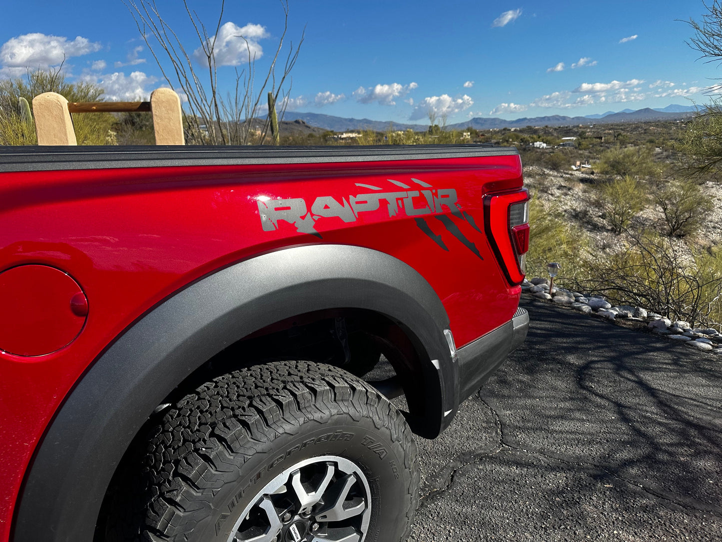 Red Ford Raptor with black matte bedside claw decals